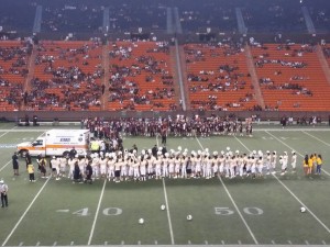 Mililani players gathered to support teammate Jalen Olomua, who was being placed on a stretcher and into an ambulance for a ride to the hospital Thursday night. Mililani head coach Rod York said X-rays were negative and Olomua is back home and recuperating after getting hit in the head on a tackle in a 71-28 win over Farrington. Courtesy photo