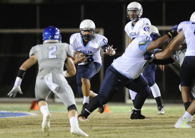 Kailua's Gabriel LeLesch hit the hole made by hit the hole made by John-Adams Naeole-Kalima (71) in Friday's 37-24 win over Moanalua. LeLesch gained 88 yards on 18 carries for the balanced Surfriders offense. Bruce Asato / Honolulu Star-Advertiser.