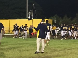 Waipahu coach Bryson Carvalho wielded the Jolly Roger flag to honor his team's seniors after the game.
