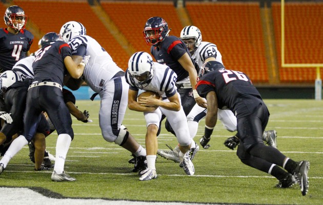 Kamehameha quarterback Thomas Yam was in the end zone with his third TD run as Saint Louis DB Dylan Toilolo approached. Photo by George F. Lee/Star-Advertiser. (Sept. 12, 2015)