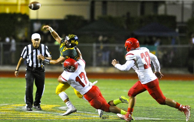 Kahuku’s Aaron Tapusoa pressures Leilehua's Kona Andres, who got hurt on the play but returned later in the second quarter. Bruce Asato / Star-Advertiser