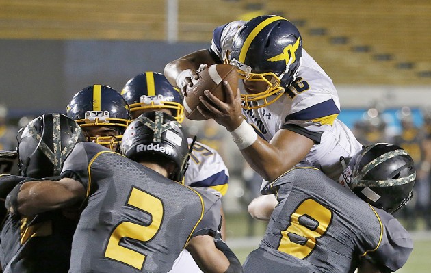 Punahou quarterback Ephraim Tuliloa went over the top of Del Oro (Loomis, Calif.) defenders for a touchdown in the Buffanblu's 22-15 victory on Sept. 4 at California Memorial Stadium on the campus of Cal-Berkeley. Punahou, the No. 2 team in the Honolulu Star-Advertiser Top 10, is the third-ranked Hawaii team by MaxPreps.com. in its national computer rankings. Tony Avelar / Special to the Honolulu Star-Advertiser.