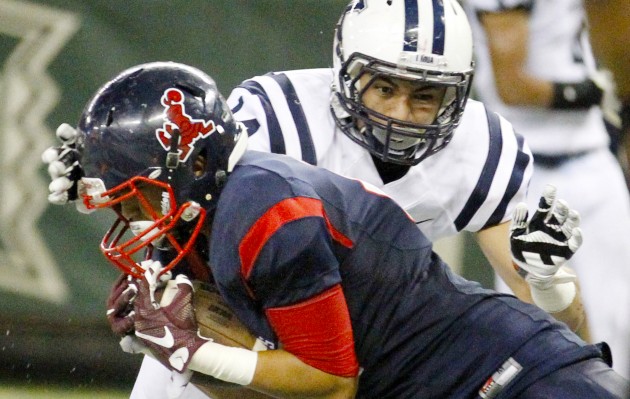 Saint Louis' Chandler Washington Villanueva made a touchdown catch in front of Kamehameha's Kamaehu Kamaka on Saturday. The Crusaders won the game 31-27 and remained in the top spot of the Honolulu Star-Advertiser's Top 10.  George F. Lee / Honolulu Star-Advertiser.