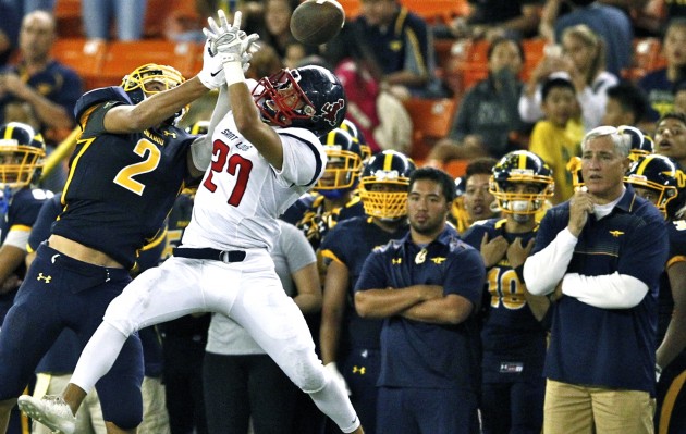 Saint Louis' Ronson Timbreza, pictured breaking up a Punahou pass, came down with an late-game interception that was the final blow to Punahou's comeback attempt.  The Crusaders won the ILH Division I championship game, 27-23, at Aloha Stadium. Jamm Aquino / Honolulu Star-Advertiser.