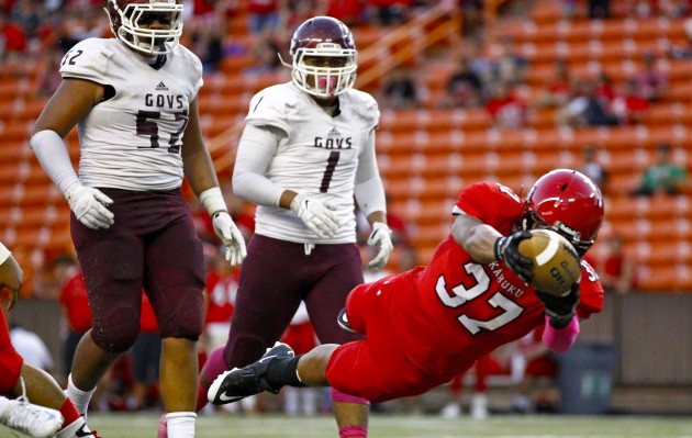 Kahuku's Sefa Ameperosa dove into the end zone during the Red Raiders' 43-0 win over Farrington in the OIA semifinals last Friday at Aloha Stadium. Kahuku moved up 47 spots to No. 86 in the MaxPreps national computer rankings. Jamm Aquino / Honolulu Star-Advertiser.