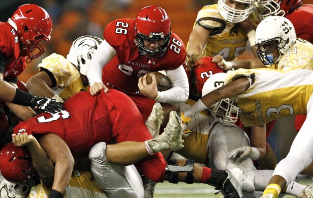 Kahuku's Kesi Ah-Hoy picks up yardage early in a 20-7 win over Mililani for the OIA Division I football championship on Friday night. Jamm Aquino/Star-Advertiser