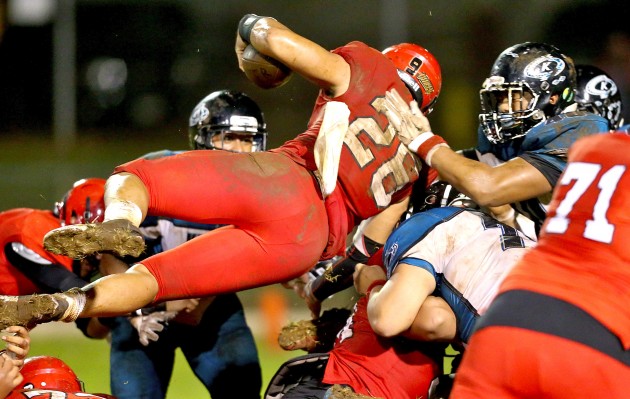 Kahuku's Kesi Ah Hoy (26) attempts to reach the end zone but is denied by Kapolei's defense during the second quarter of the game on Saturday at Kahuku High School. Jay Metzger/Special to Star-Advertiser