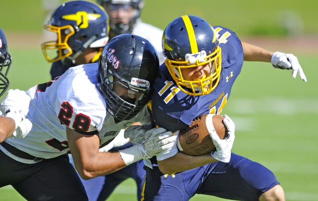 Punahou is No. 1 in Hawaii in the Honolulu Star-Advertiser poll, but the Buffanblu are behind Mililani in the MaxPreps national computer poll. In photo, Punahou's Eamon Brady fought for extra yards against during a 35-23 home win over ‘Iolani on Oct. 2. Bruce Asato / Honolulu Star-Advertiser.