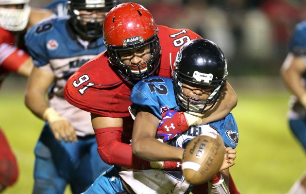 Kahuku defensive lineman Aliki Vimahi sacked Kapolei's Taulia Tagovailoa during an OIA playoff game on Oct, 17. Kahuku, the new Division I state champion, broke into the USA Today Pacific region rankings today at No. 9. Jay Metzger / Special to Star-Advertiser.