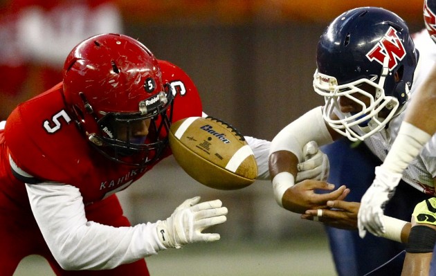The ball was up in the air in between Waianae running back Jaren Ulu, right, and Kahuku's Pesa Lefau during the state tournament semifinals last fall. The OIA-ILH football alliance took a handoff in the spring and was met by a hard tackle a month later. Will it be fumbled? Or will it be talked about by the Hawaii HIgh School Athletic Association's football committee?  Jamm Aquino / Honolulu Star-Advertiser.