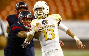 Mililani's McKenzie Milton was knocked out of the game in the second quarter with a shoulder injury. Photo by Jamm Aquino/Star-Advertiser.