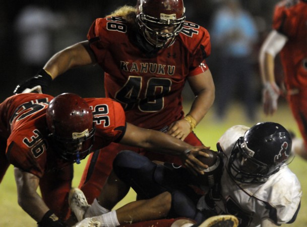 Saint Louis RB Keanu Mook-Garcia is taken down by the Kahuku defense. Photo by Scott Morifuji/Star-Advertiser.