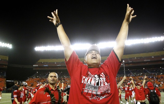 Kahuku head coach Vavae Tata lifted his arms up in celebration as time ran out on last night's 39-14 victory over Saint Louis  in the  Division I state championship game at Aloha Stadium. Jamm Aquino / Honolulu Star-Advertiser.