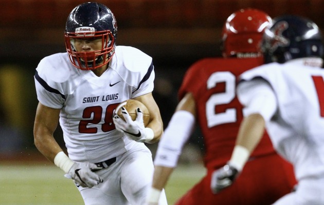 Saint Louis' Ronson Young, shown running after a reception against Kahuku, is back for his senior season. Jamm Aquino / Honolulu Star-Advertiser.