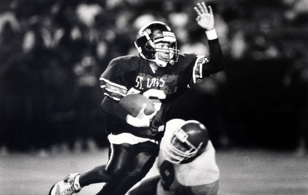 Saint Louis QB John Hao outran a Kahuku defender in the 1989 Prep Bowl. Hao threw for a career-high 329 yards in a 35-18 win. Star-Bulletin photo by Dennis Oda.