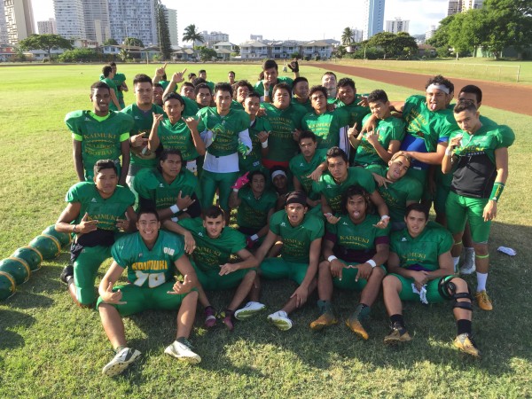 The Kaimuki Bulldogs stretch and relax before practice on Wednesday afternoon. 