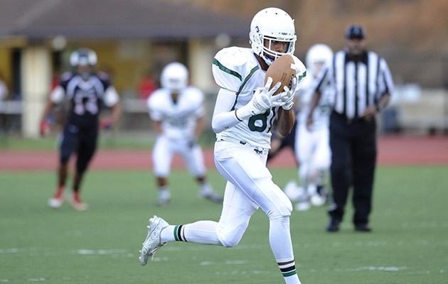 Konawaena's Reyson Ching scored on a long touchdown pass in the first quarter against Radford. Photo by Bruce Asato/Star-Advertiser.