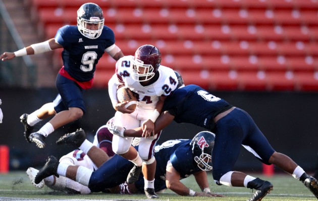 Baldwin's Kamaki Gouveia (24) is stopped by Waianae's Brandon Hattori (6) during the first half of an HHSAA quarterfinal football playoff game between the Baldwin Bears and the Waianae Seariders on Friday, November 6, 2015 at Aloha Stadium in Halawa. Jamm Aquino/Star-Advertiser