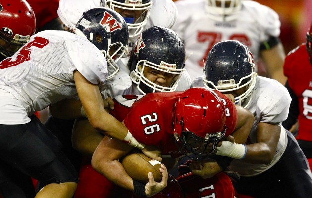 Waianae's defense did all it could against Kahuku on Friday night. Jamm Aquino / Star-Advertiser