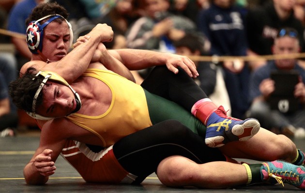 Leilehua's Liam Corbett, bottom, is going for a second state title against ‘Iolani's KJ Pascua (not pictured) on Saturday in the 152-pound final. Pascua is also going for his second state crown. Bruce Asato / Honolulu Star-Advertiser.