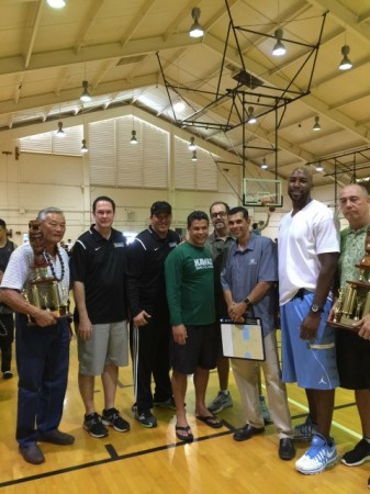 New 1987 and 1988 boys basketball state-title trophies are at the University Laboratory School's gym. The original trophies were lost in a 2006 fire. From left to right are members from those 1987 and 1988 teams — Bobby Au ('87 coach), Keoni Jeremiah, Ryan Tong, Danny Alvarez, Jim Bukes, Walt Quitan, James Williams and Darryl Gabriel ('88 coach). Courtesy of University Laboratory School.