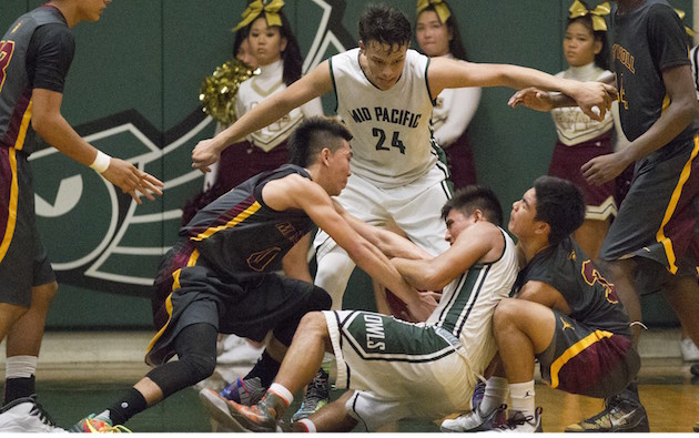 Mid-Pacific's Daniel Florenco battled two Maryknoll players for the ball in a game earlier this season. Photo by Cindy Ellen Russell/Star-Advertiser.