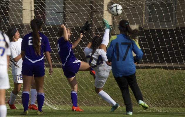 Hilo's Kalamanamana Harman used a bicycle kick to deny this Pearl City attack. Three Chargers had scoring chances in succession denied by Harman, including Daelenn Tokunaga, left, and Jenise Starr-Tagalog. Hilo goalkeeper Saydee Bactad (17) caught the bicycle kick that went up in the air. Cindy Ellen Russell / Honolulu Star-Advertiser.