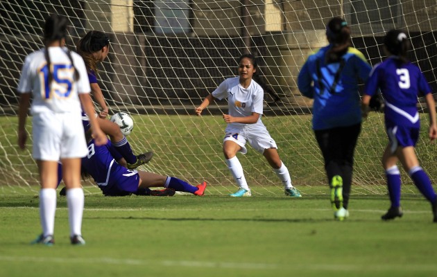 The ball caroms away from Hilo's Kalamanamana Harman, center, after this point-blank shot by Pearl City's Jenise Starr-Tagalog (on ground). This was Harman's second of three stops in about a 10-second span. Cindy Ellen Russell / Honolulu Star-Advertiser.