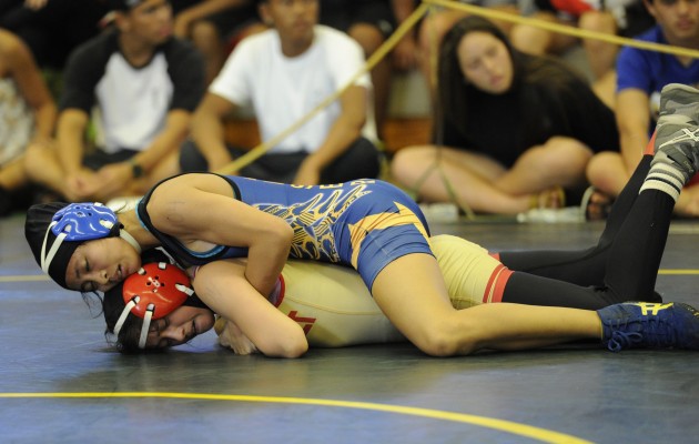 Kaiser's Tiare-Lynn Ikei beat Roosevelt's Xiaolin Mai at 104 pounds in the OIA Championships. Photo by Bruce Asato/Star-Advertiser.