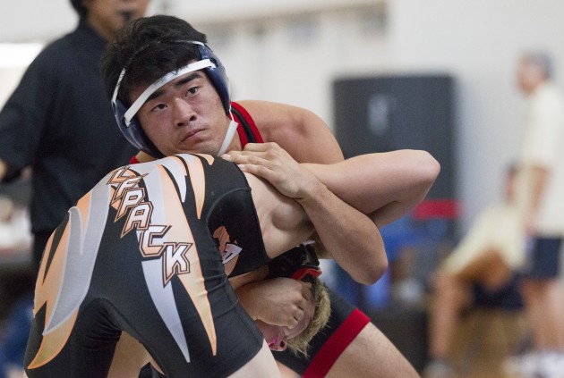 'Iolani's Jake Nakasone watched the clock while Pac-Five's Josh Matsumoto tried to escape in a match last month. Photo by Cindy Ellen Russell/Star-Advertiser.