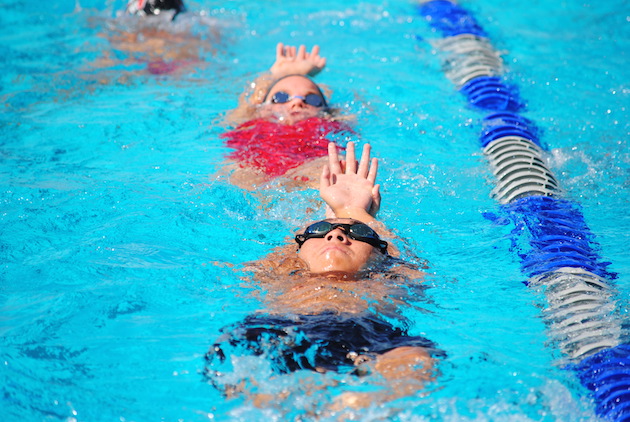 Swimmers warmed up for the opening day of the HHSAA Swimming and Diving State Championships at KS-Hawaii. Photo by Jerry Campany/Star-Advertiser.