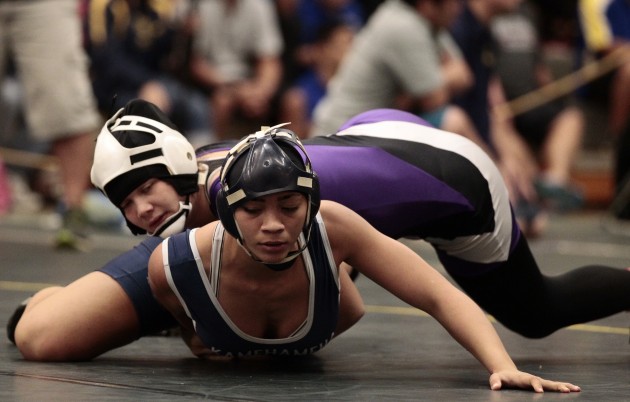 Kamehameha's Zion Vierra worked for an escape against Pearl City's Asia Evans in the girls 127-pound final at Officials. Photo by Jamm Aquino/Star-Advertiser.