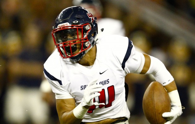 Saint Louis linebacker Isaac Slade-Matautia (14) carries the ball during the first half of an ILH football game against Punahou Buffanblu on Friday, Sept. 25, 2015 at Aloha Stadium.