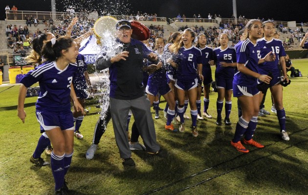 Pearl City players doused coach Frank Baumholtz after winning the 2016 Division I girls soccer state championship. The Chargers will attempt to repeat this season. Bruce Asato / Star-Advertiser