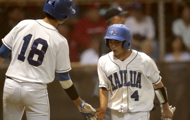 Kailua's Dustin Imanaka (4) shakes hands with Joey Cantillo (18) after scoring during the third inning of the 2016 OIA Division I baseball championship game between the Kailua Surfriders and the Kalani Falcons on Saturday, April 23, 2016 at Hans L'Orange Park in Waipahu.  Kailua won 7-5. Jamm Aquino/Star-Advertiser