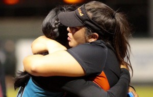 Campbell designated player Elisa Favela, right, embraced Kapolei pitcher Sadie Kapaku-You after the Sabers' 12-2 win for the state title Friday at Rainbow Wahine Softball Stadium. Jamm Aquino / Honolulu Star-Advertiser.