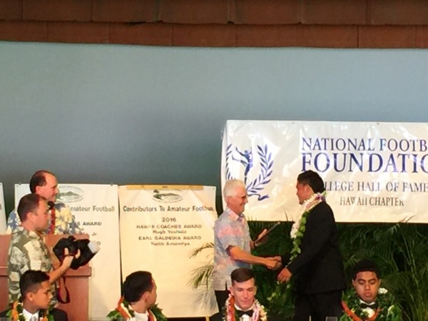 Kahuku senior Keala Santiago is presented his plaque as one of the 12 honorees.
