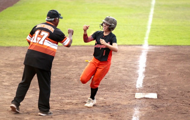 Campbell's Cydney Curran fist-bumped head coach Michael Hermosura while rounding the bases during her two-run, sixth-inning home run. Jamm Aquino / Honolulu Star-Adverters.