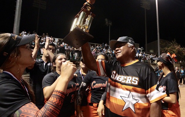 Campbell head coach Michael Hermosura presented the 2016 softball state championship trophy to his Sabers after a 12-2 win over Kapolei. Jamm Aquino / Honolulu Star-Advertiser.