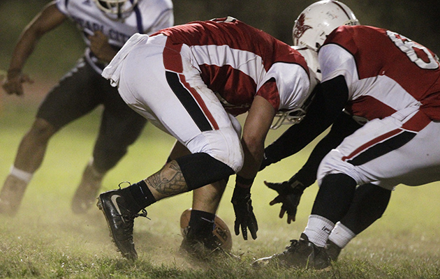 Kalani's Payton Awaya recovered a fumble with help from teammate Keali'i Lopes in a game against Pearl City last season. Photo by Krystle Marcellus/Star-Advertiser.