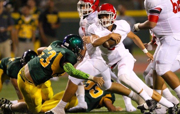 Kahuku QB Sol-Jay Maiava scrambled for yards against Leilehua in his first high school game. Photo by Jamm Aquino/Star-Advertiser.