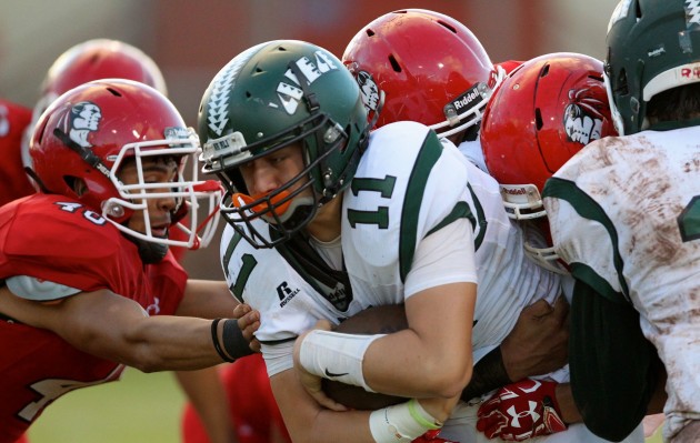 Aiea challenges Leilehua on Saturday in the first round of the OIA playoffs. In photo, Na Alii's  Kame Kim Choy-Keb-Ah Lo went up against Kahuku defenders earlier this year. Jamm Aquino / Honolulu Star-Advertiser.