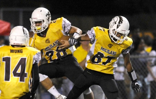 Mililani’s Kailiohu Kila and Ryan Chang celebrate Kila's touchdown run in the third quarter against Farrington on Saturday. Photo by Bruce Asato/Star-Advertiser.