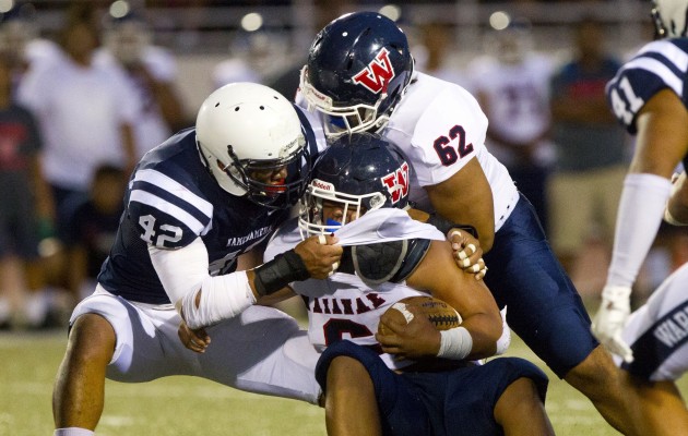Kamehameha defensive end Andrew Aleki grabbed Waianae running back Rico Rosario in the first quarter of a game in 2016. Photo by Cindy Ellen  Russell/Star-Advertiser.