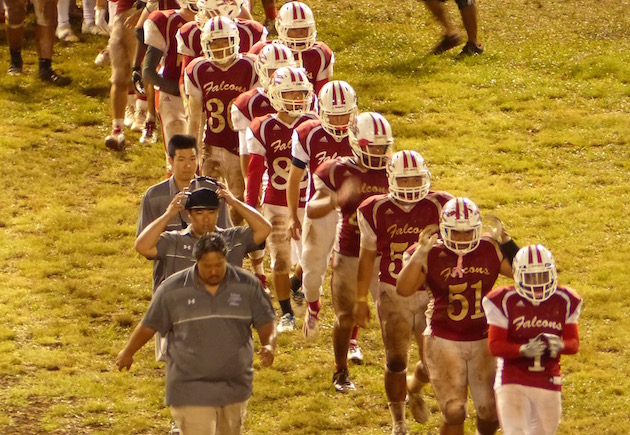 Kalani coach Scott Melemai, bottom left, led the Falcons in the postgame handshake line after picking up his first win as Kalani head coach last weekend. Photo by Kaylee Noborikawa/Star-Advertiser.