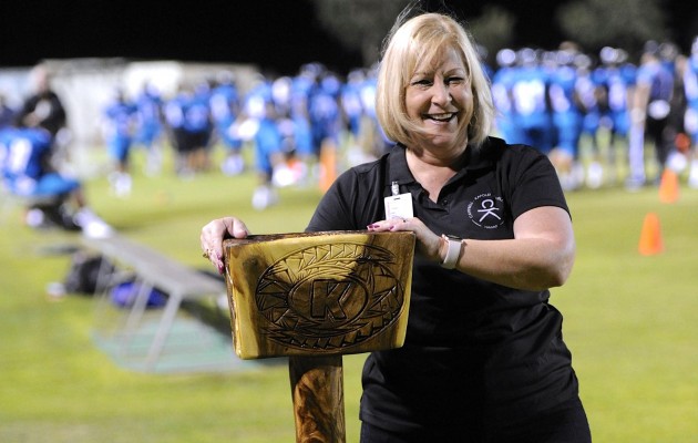 Heidi Armstrong, the Campbell-Kapolei complex area superintendent, held the "Sledgehammah" perpetual trophy during the Hurricanes vs. Sabers football game Friday night. Bruce Asato / Honolulu Star-Advertiser.