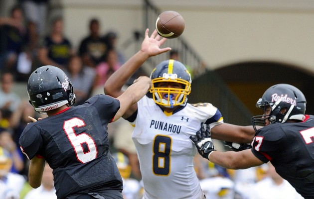 2015 September 11 SPT - HSA PHOTO BY BRUCE ASATO  - Punahou’s Miki Suguturaga rushes Iolani’s quarterback Tai-John Mizutani and deflects a pass in the third quarter of the Punahou vs Iolani football game at Iolani's Eddie Hamada Track and Field, Friday, September 11, 2015.