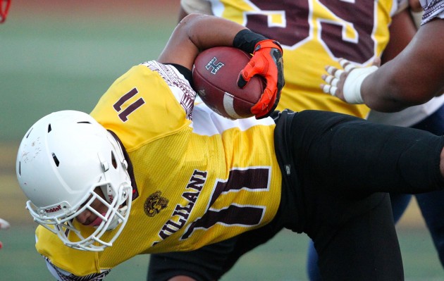 Mililani WR Roman Tovi dove for extra yardage in the first quarter of the Trojans' canceled game against Saint Louis. Photo by Jamm Aquino/Star-Advertiser.