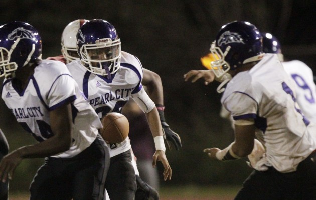 Pearl City's Isaiah Asinsin handed off to Joe Maneafaiaga in a game against Kalani last season. Photo by Krystle Marcellus/Star-Advertiser.