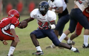 Jaylen Mitchell avoided the tackle of Kahuku defender Kawehena Johnson in a game at Carlton Weimer Field in 2010. Photo by FL Morris/Star-Advertiser.